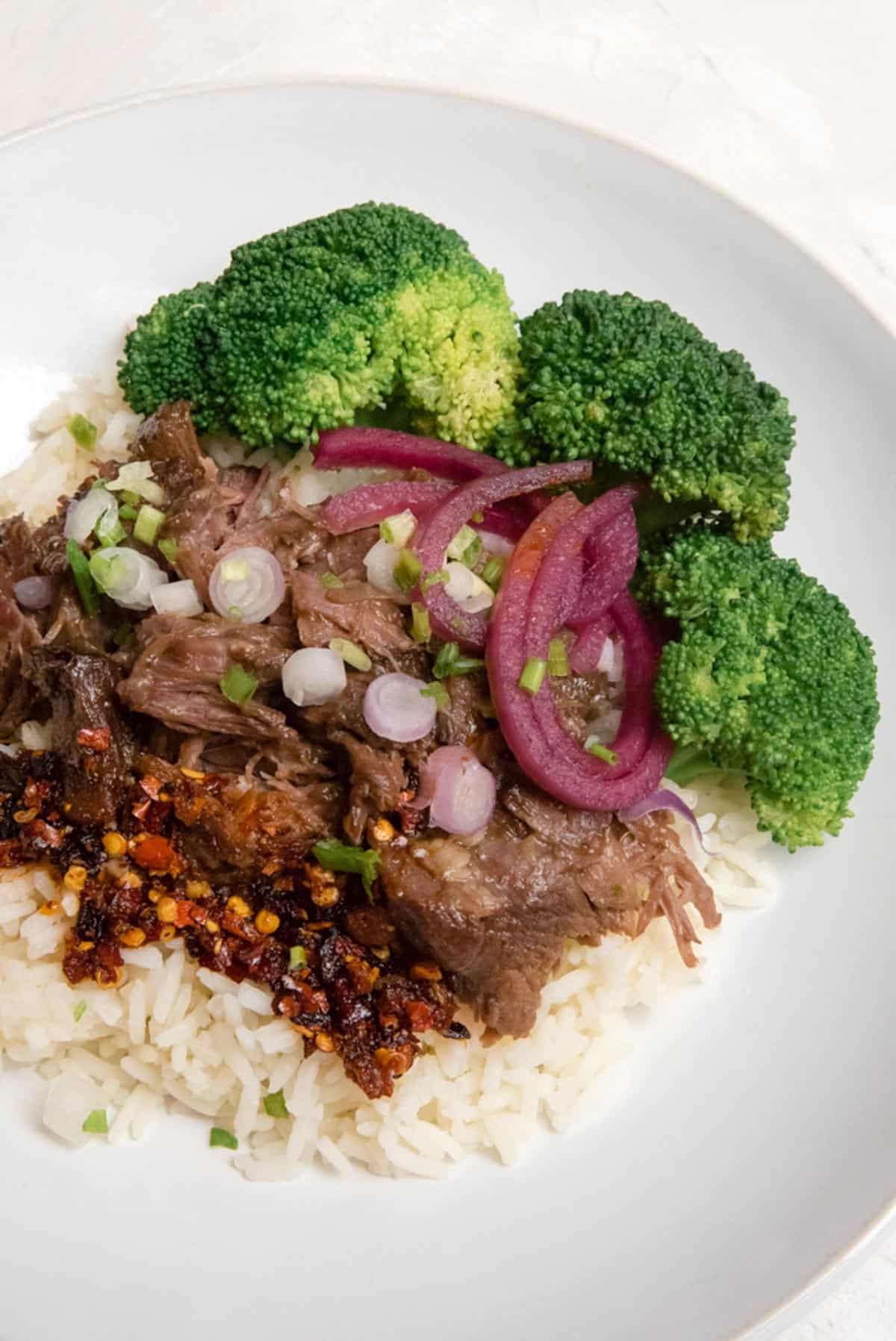 Close up of Korean Beef Bowl in a shallow white dish.