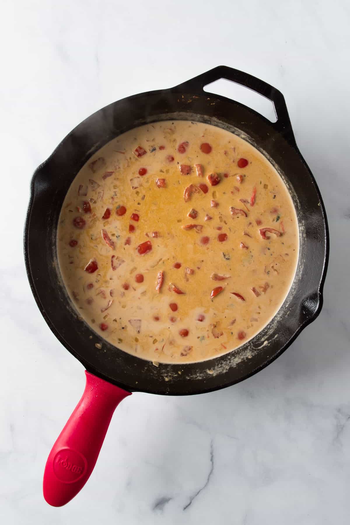 Ingredients for cream sauce in a cast iron pan for veggie turkey meatballs.