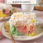 A square of Colorful Easter Poke Cake on a pastel floral plate, on a pink backdrop. More cake and a glass of milk are out of focus in the background. Graphics for Pinterest over the photo.