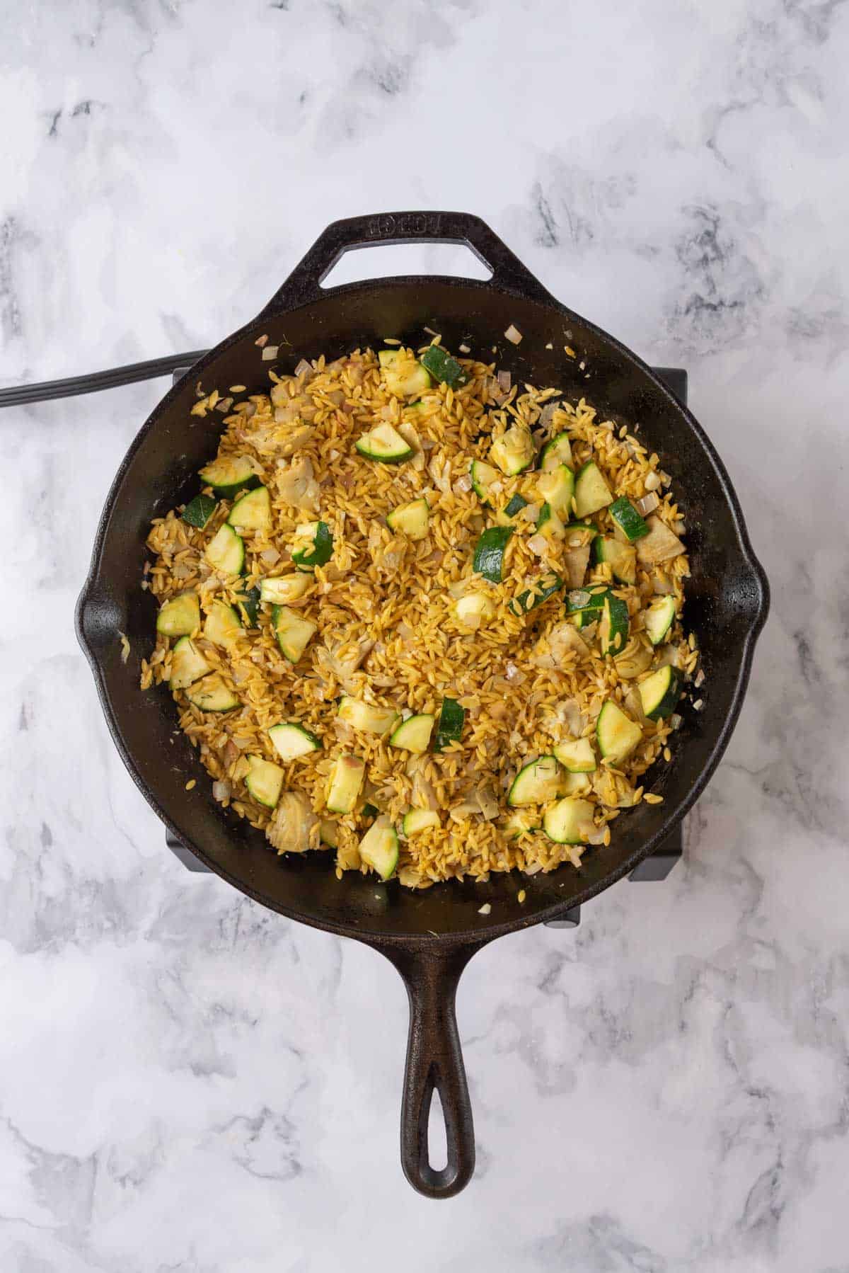 Toasting the orzo pasta in the skillet with the sauteed vegetables.