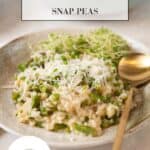 A beautiful cream and green shallow pottery bowl filled with Fresh Spring Risotto with Asparagus & Snap Peas and a gold spoon. The braising pan full of risotto in the background. Graphics over top naming the dish.