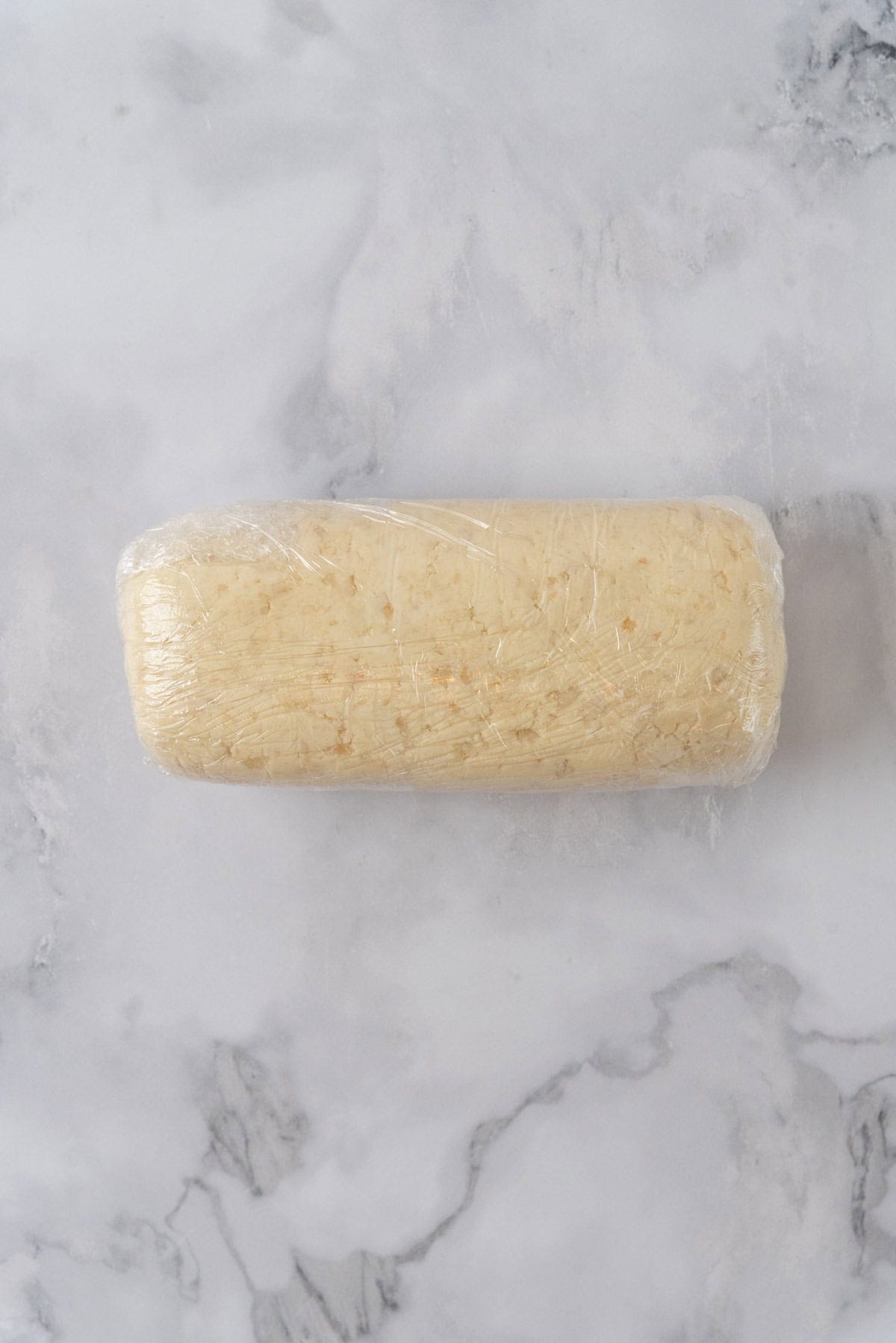 Shortbread cookie dough rolled into a log and wrapped tight in plastic wrap.
