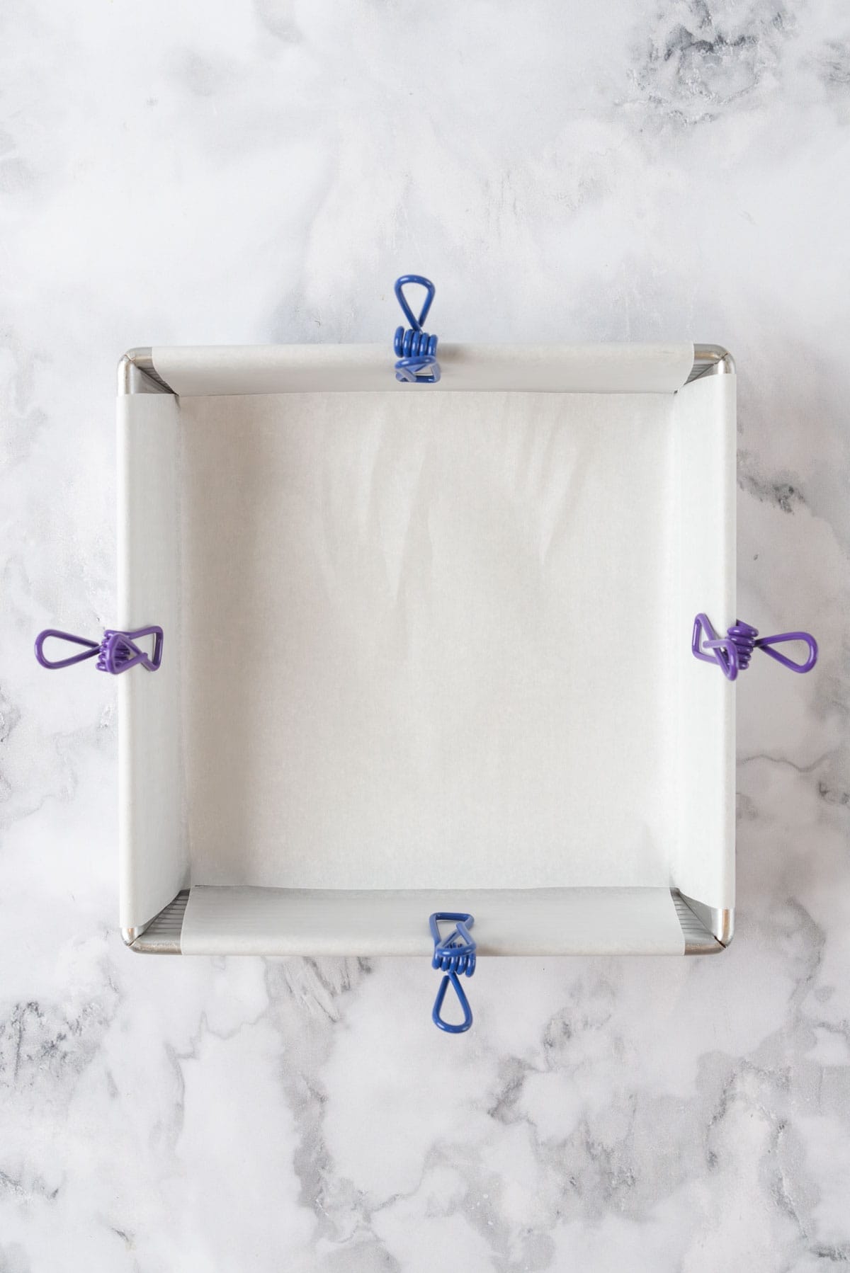 An 8x8 pan, prepared with parchment paper.