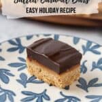 A closeup of a chocolate espresso bar on a white plate with delicate blue leaves.