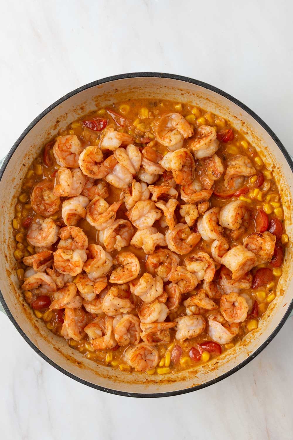 Seared shrimp added back into the sauce to warm up.