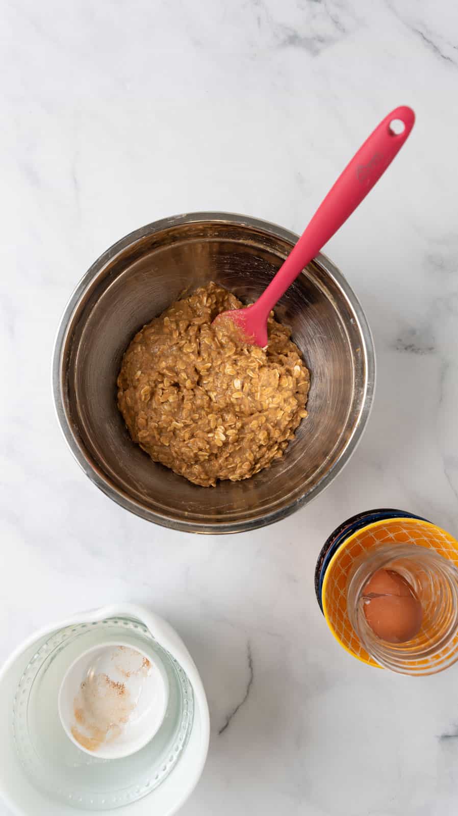 A stainless steel mixing bowl with the breakfast bar batter ready to be poured into the baking pan.